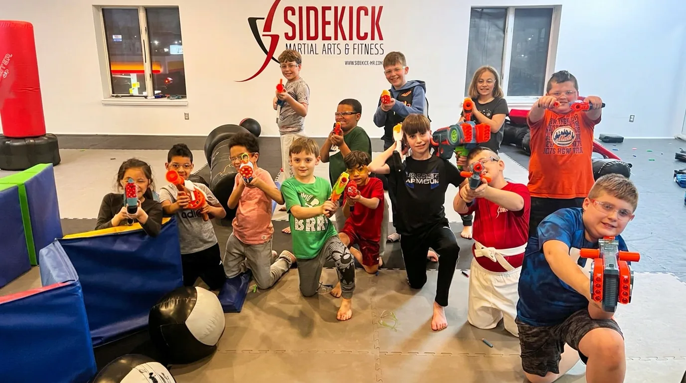 Kids with foam blasters posing together at a Sidekick martial arts birthday party
